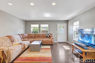 Castle Rock house for rent - A living room with a large leather sofa and a coffee table.