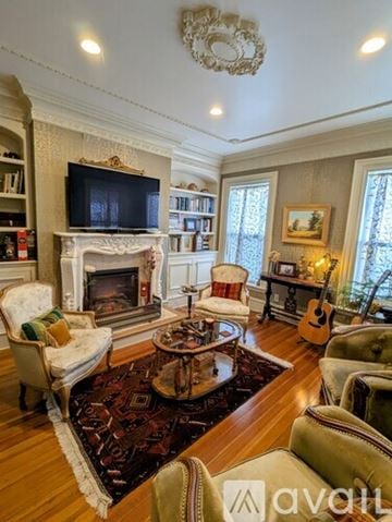 Hull house for rent - A living room with a fireplace and a television on the mantle.