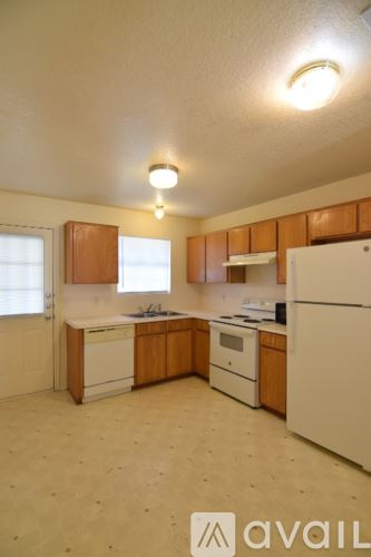 Killeen apartment for rent - A kitchen with wooden cabinets and white appliances.