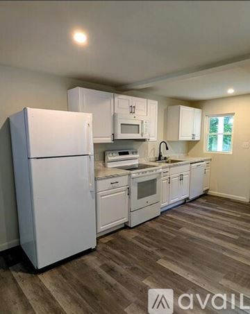 Parkesburg house for rent - A kitchen with white appliances and cabinets.