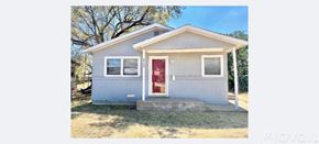 Lubbock house for rent - A small white house with a red door is for lease.