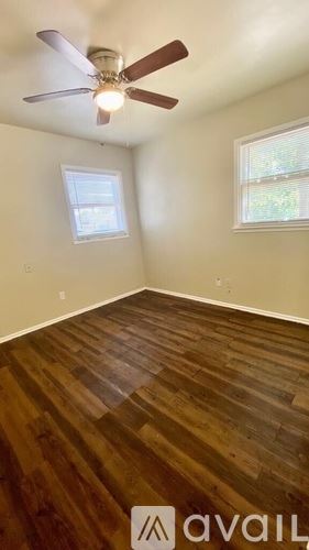 Lubbock house for rent - A room with a ceiling fan and wooden flooring.