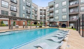 Lehi apartment for rent - A large outdoor swimming pool surrounded by apartment buildings.