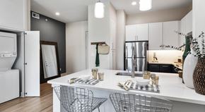Lehi apartment for rent - A modern kitchen with white cabinets and a white island.