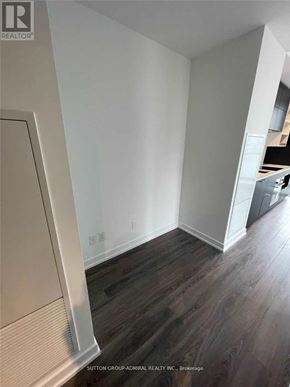 Toronto (Bay Street Corridor) condo for rent - A room with wood flooring and white walls.