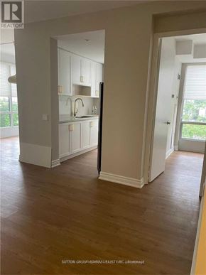Toronto (Church-Yonge Corridor) condo for rent - A room with wooden floors and white walls, with a doorway leading to another room.