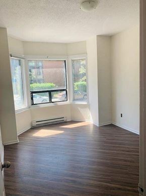Toronto apartment for rent - A room with a window seat and a door.