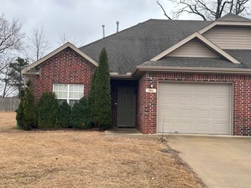Centerton house for rent - A house with a garage door numbered 241.