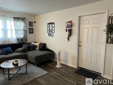Merrillville apartment for rent - A living room with a grey couch and a coffee table.