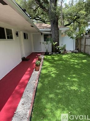 Miramar apartment for rent - A white house with a red carpet and a green lawn.