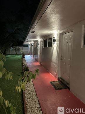 Miramar apartment for rent - A long hallway with lights on the wall and doors on the side.