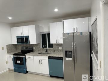 Miramar apartment for rent - A kitchen with white cabinets and a stainless steel refrigerator.