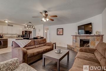 Allen house for rent - A living room with a brown couch and a fireplace.