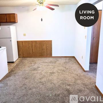 Milford apartment for rent - A living room with a carpet floor and a ceiling fan.