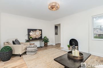 Cincinnati apartment for rent - A living room with a fireplace and a painting on the wall.