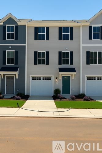 Charlotte house for rent - A kitchen with white cabinets and a stainless steel refrigerator.