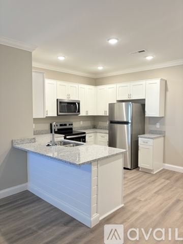 Bowling Green apartment for rent - A kitchen with white cabinets and a marble countertop.