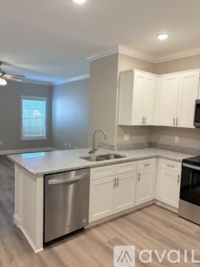 Bowling Green apartment for rent - A kitchen with white cabinets and a granite countertop.