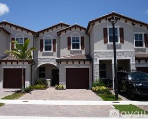 Miami townhouse for rent - A house with a black car parked in front.