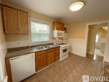 Elmira apartment for rent - A kitchen with a white dishwasher and a white microwave.