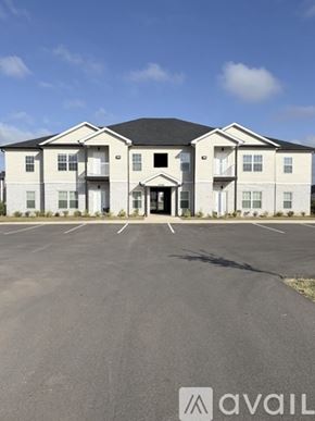 Bowling Green apartment for rent - A large white building with a black roof and a parking lot in front.
