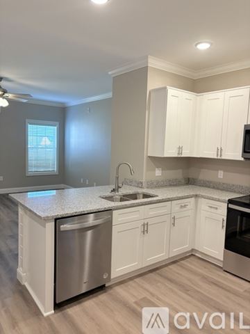 Bowling Green apartment for rent - A kitchen with white cabinets and a granite countertop.