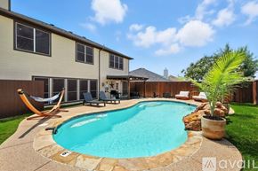 Burleson house for rent - A swimming pool in a backyard with a hammock and patio furniture.