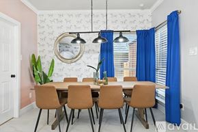 Burleson house for rent - A dining room with a table set for six and a mirror on the wall.