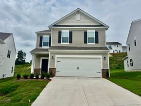 Taylors house for rent - A two-story house with a garage door and a driveway.