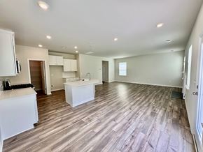 Taylors house for rent - A spacious room with wooden flooring and white cabinetry.