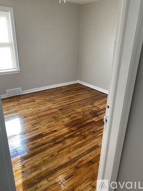 Detroit house for rent - A room with wooden flooring and a window.
