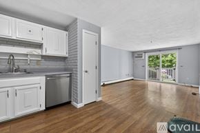 Billerica condo for rent - A bedroom with a large bed and a wooden dresser.