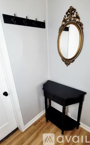 Moline apartment for rent - A black table with a mirror above it.