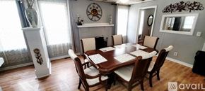 Moline apartment for rent - A dining room with a wooden table surrounded by chairs.