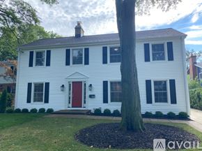 Winnetka house for rent - A white house with a red door and black shutters.