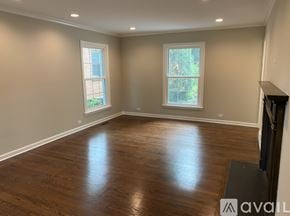 Winnetka house for rent - A spacious room with wood flooring and two windows.