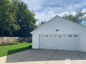 Winnetka house for rent - A white garage with a wooden fence and trees in the background.