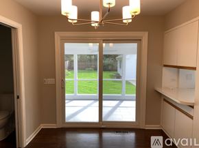 Winnetka house for rent - A room with a sliding glass door leading to a backyard.