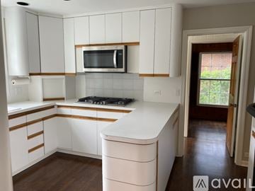 Winnetka house for rent - A kitchen with white cabinets and a white counter top.
