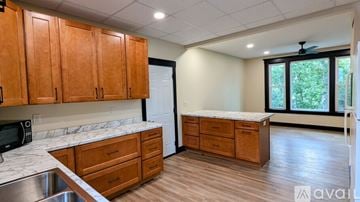Eau Claire apartment for rent - A kitchen with wooden cabinets and a white countertop.