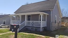 Greenville house for rent - A house with a grey exterior and a white porch.