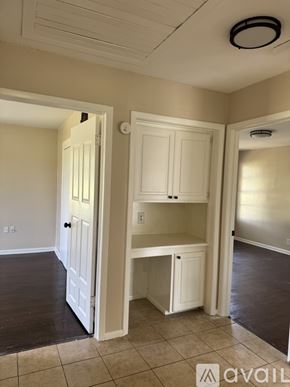Hutchins house for rent - A kitchen area with a white cabinet and a white door.