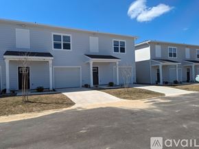 Defuniak Springs townhouse for rent - A row of modern townhouses with a clear blue sky above.