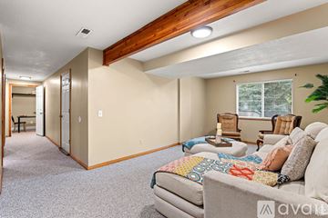 Sandy apartment for rent - A living room with a couch and a chair.
