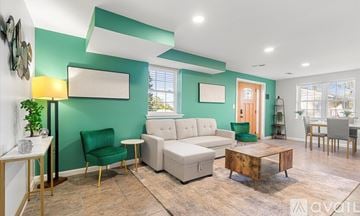 Alexandria apartment for rent - A living room with a green chair and a white couch.