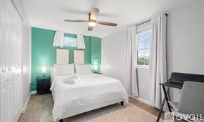 Alexandria apartment for rent - A bedroom with a white bed and a ceiling fan.