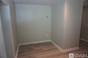 Baltimore apartment for rent - A room with wooden flooring and white walls.