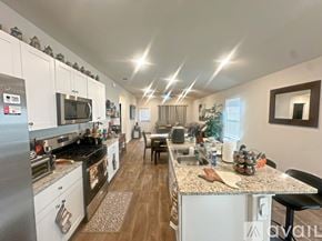 San Antonio house for rent - A kitchen with white cabinets and a stainless steel refrigerator.