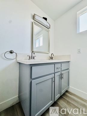Los Angeles townhouse for rent - A bathroom with a white countertop and a grey cabinet.