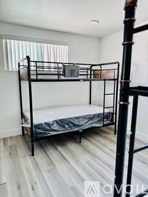 Los Angeles townhouse for rent - A bunk bed with a mattress on top and a ladder on the side.